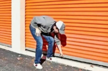 When he spots a safe in a storage container, the man falls to his knees